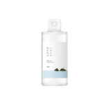ROUND LAB 1025 Dokdo Toner bottle front view Watery texture of ROUND LAB Dokdo Toner on hand Applying Dokdo Toner with cotton pad on face ROUND LAB 1025 Dokdo Toner packaging featuring deep sea water design