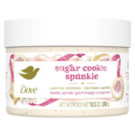 Dove Sugar Cookie Sprinkle Body Scrub jar with festive packaging Close-up of Dove vanilla sugar body scrub texture Woman using Dove body scrub in shower for glowing skin Dove holiday body scrub with sugar granules and creamy formula Dove Sugar Cookie scrub lifestyle image with cozy festive theme